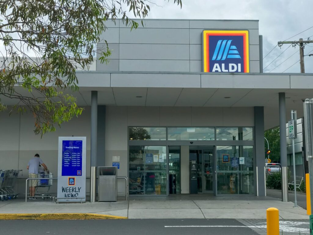exterior view of Aldi's new store format in the us ,showing the modern storefront design. 