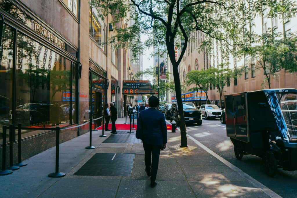 Street view of Rockefellers Center New York with NBC Studios and Rainbow Room sign in the background showing media influence on US finance and  stock market trends 