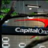An official capital one building entrance with the red and blue logo visible behind the glass. This is the headquarters involved in the $425 million 360 savings class-action settlement claim process.