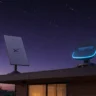 Amazon Leo vs Starlink satellite internet dishes installed on a modern home roof.