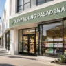 A modern commercial storefront displaying the Olive Young Pasadena brand name on a city street corner.