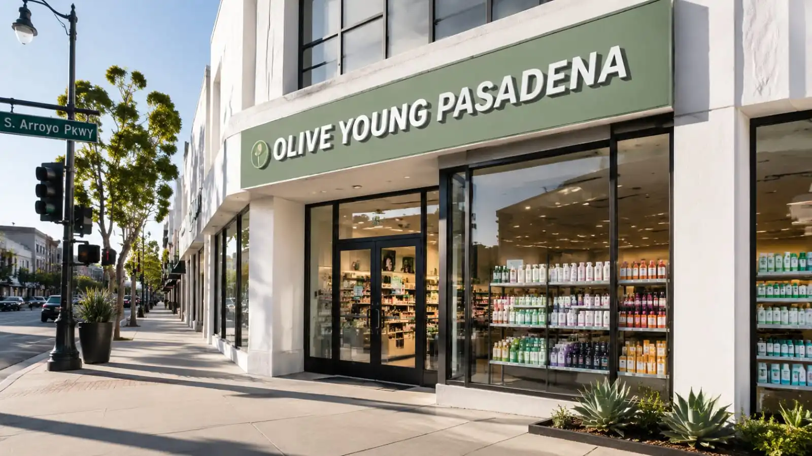 A modern commercial storefront displaying the Olive Young Pasadena brand name on a city street corner.