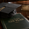 A graduation cap on top of a savings book representing a legal tax benefit 529 plan setup.